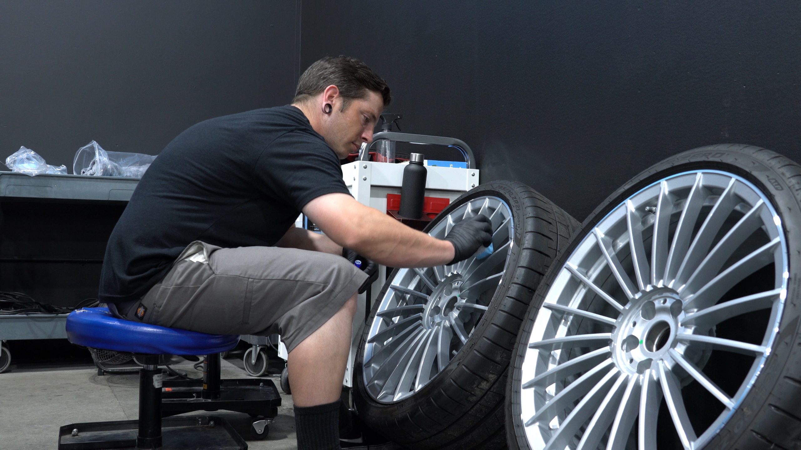 Detailer applying Ceramic Coating to Wheels.